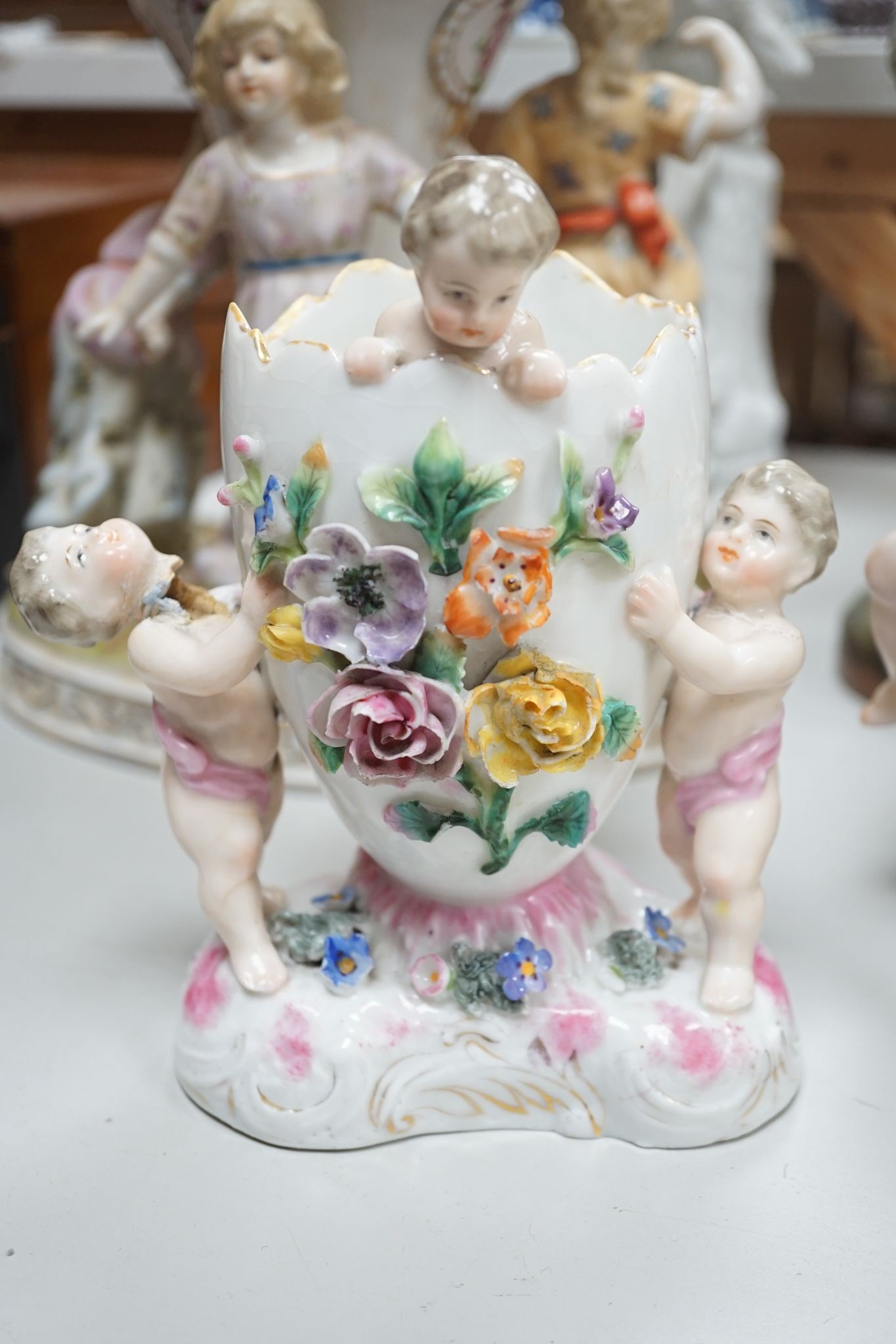 A group of Continental porcelain and pottery figural vases and centrepieces and two candelabra